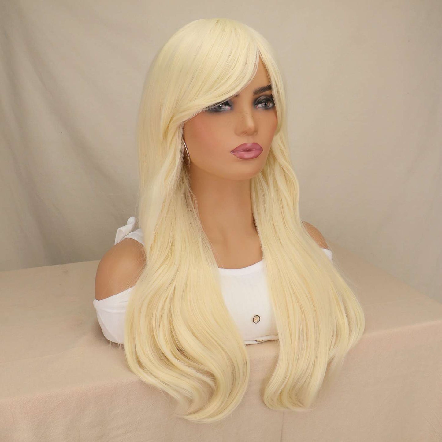 Long blonde straight wig displayed on mannequin showing full length and natural texture