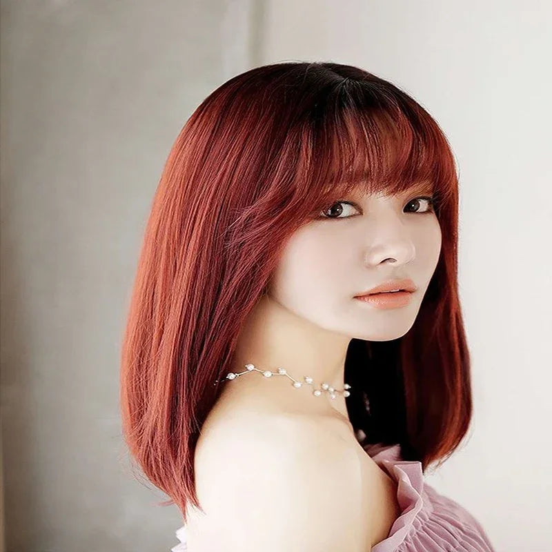 Premium auburn-brown heat-resistant wig displaying rich mahogany tones with natural shine, featuring adjustable cap and breathable construction details