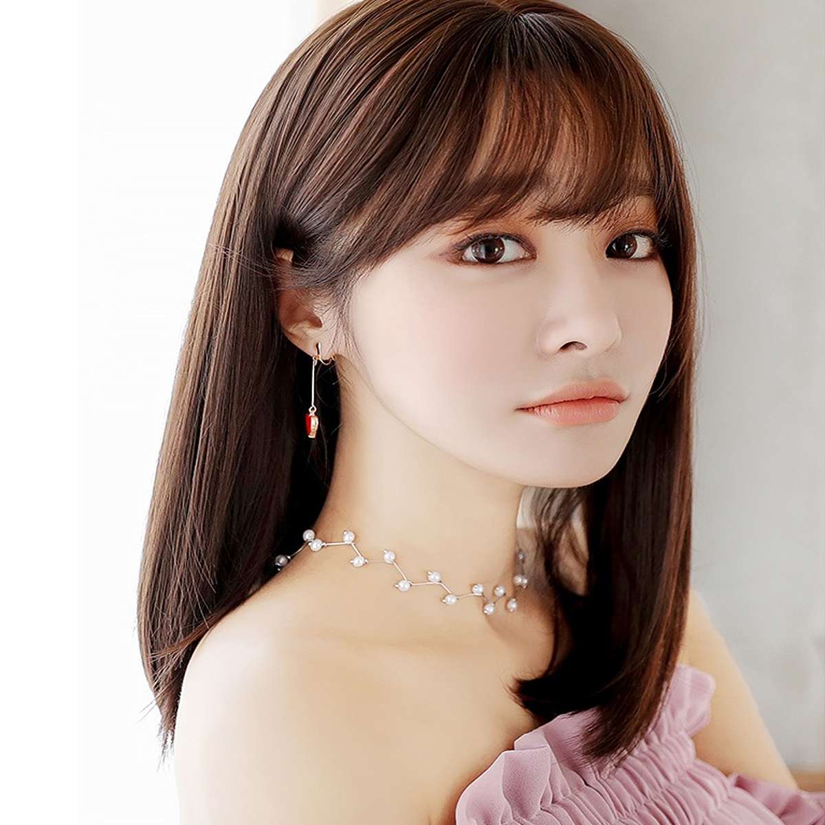 Luxe straight synthetic wig styled with accessories demonstrating versatile heat-resistant styling options and elegance