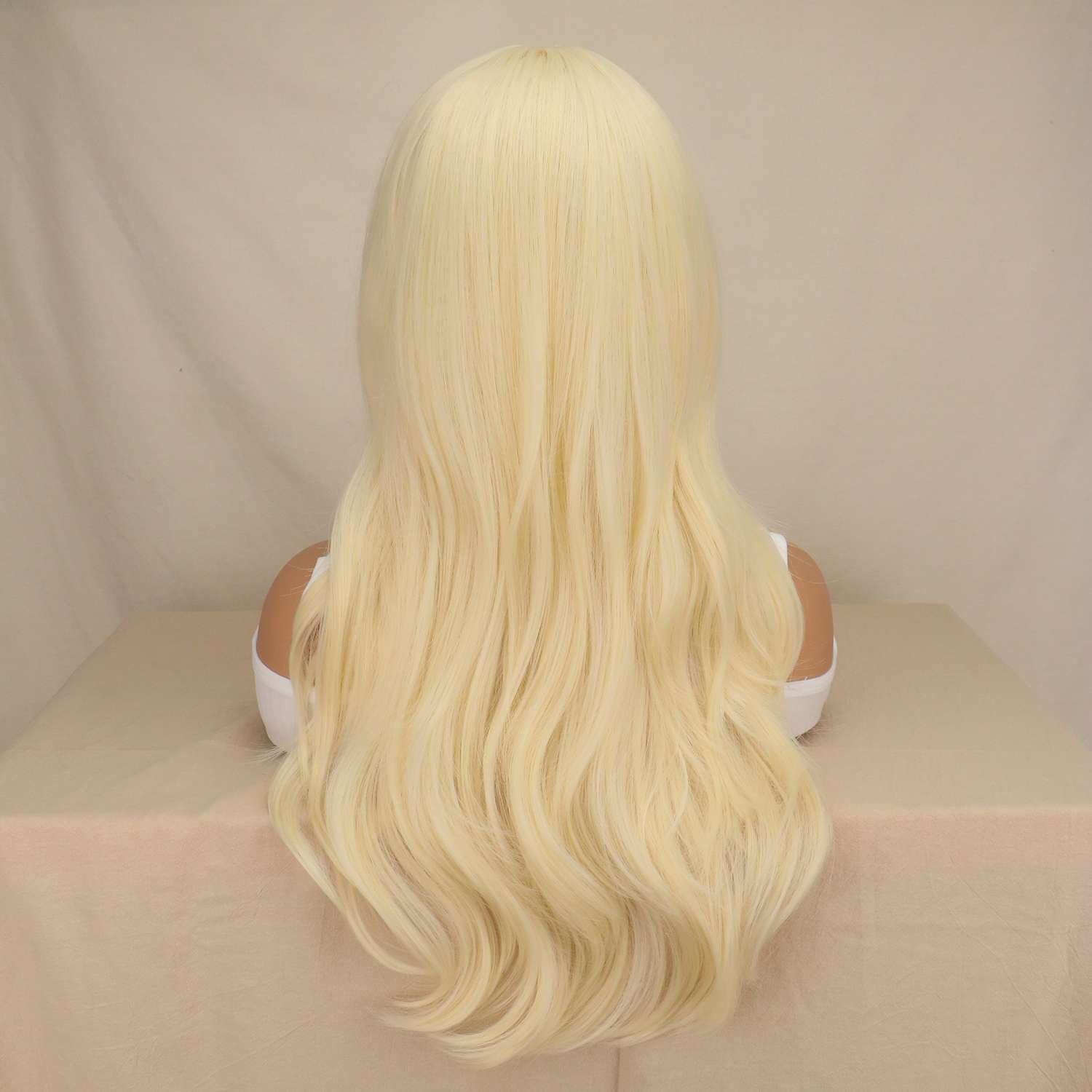 Woman wearing long blonde straight wig with soft waves and natural movement