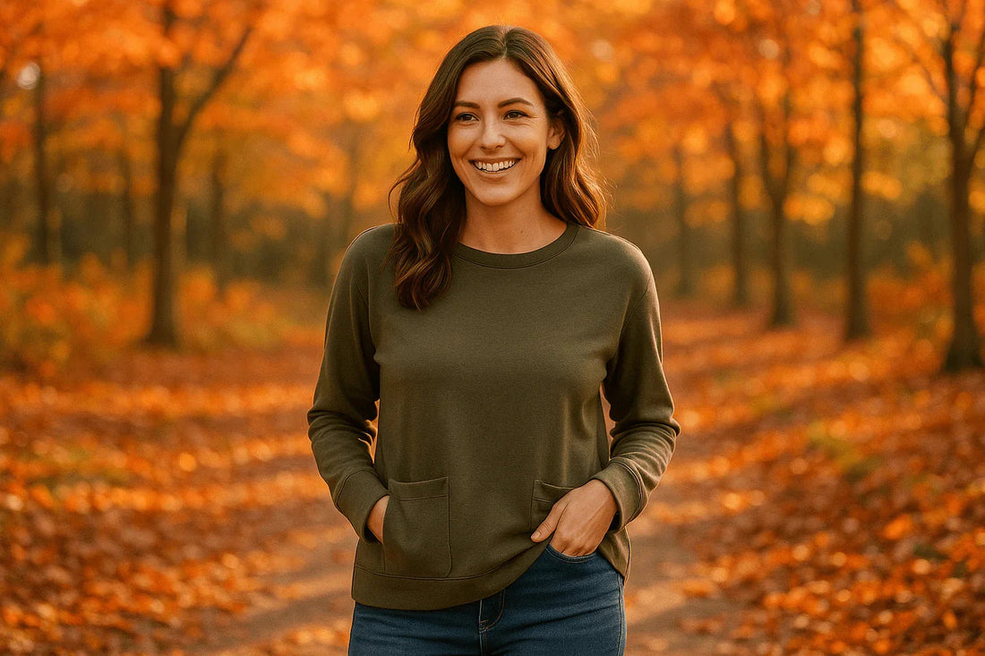 Woman wearing olive green casual pocket top and jeans in autumn forest with orange leaves
