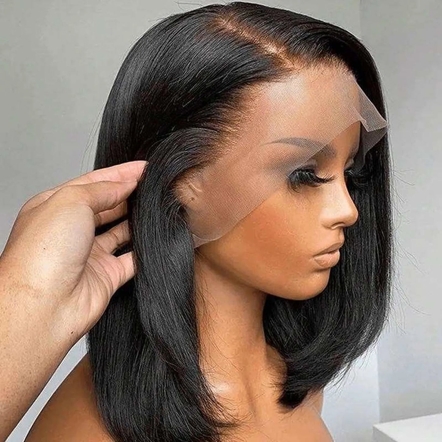 Human hair bob wig natural black straight texture worn by model side angle